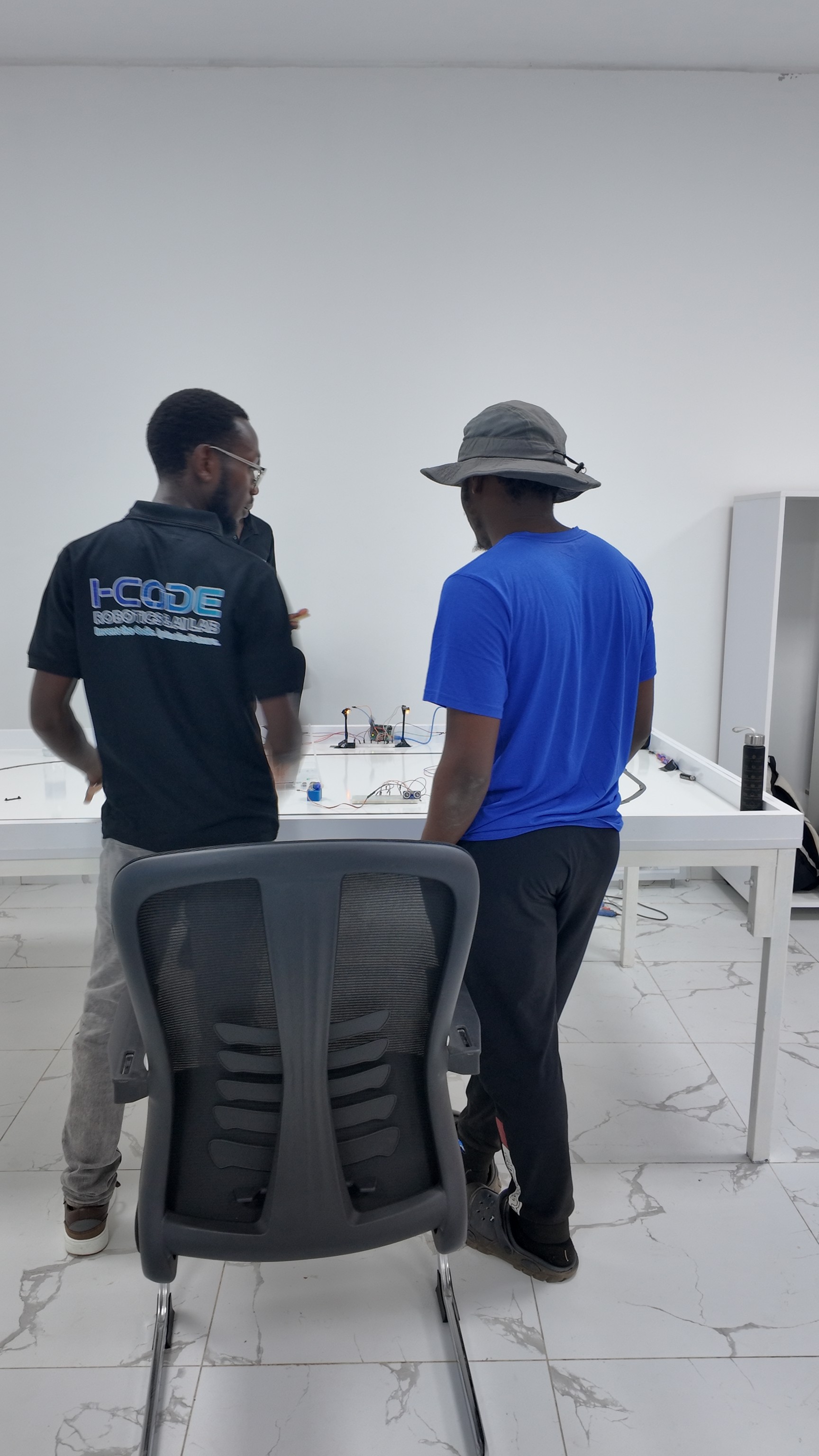 i-CODE instructor guiding student through electronics project