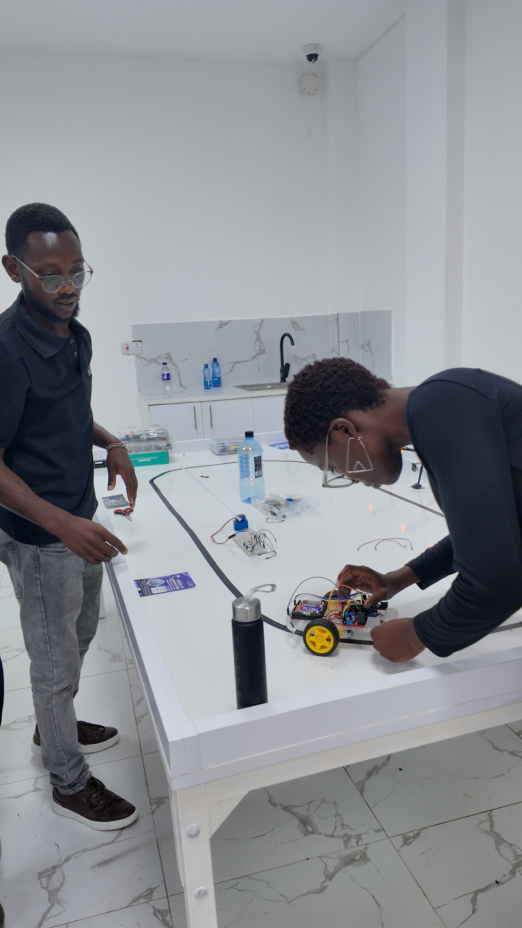 Student positions line-following robot on track for test run