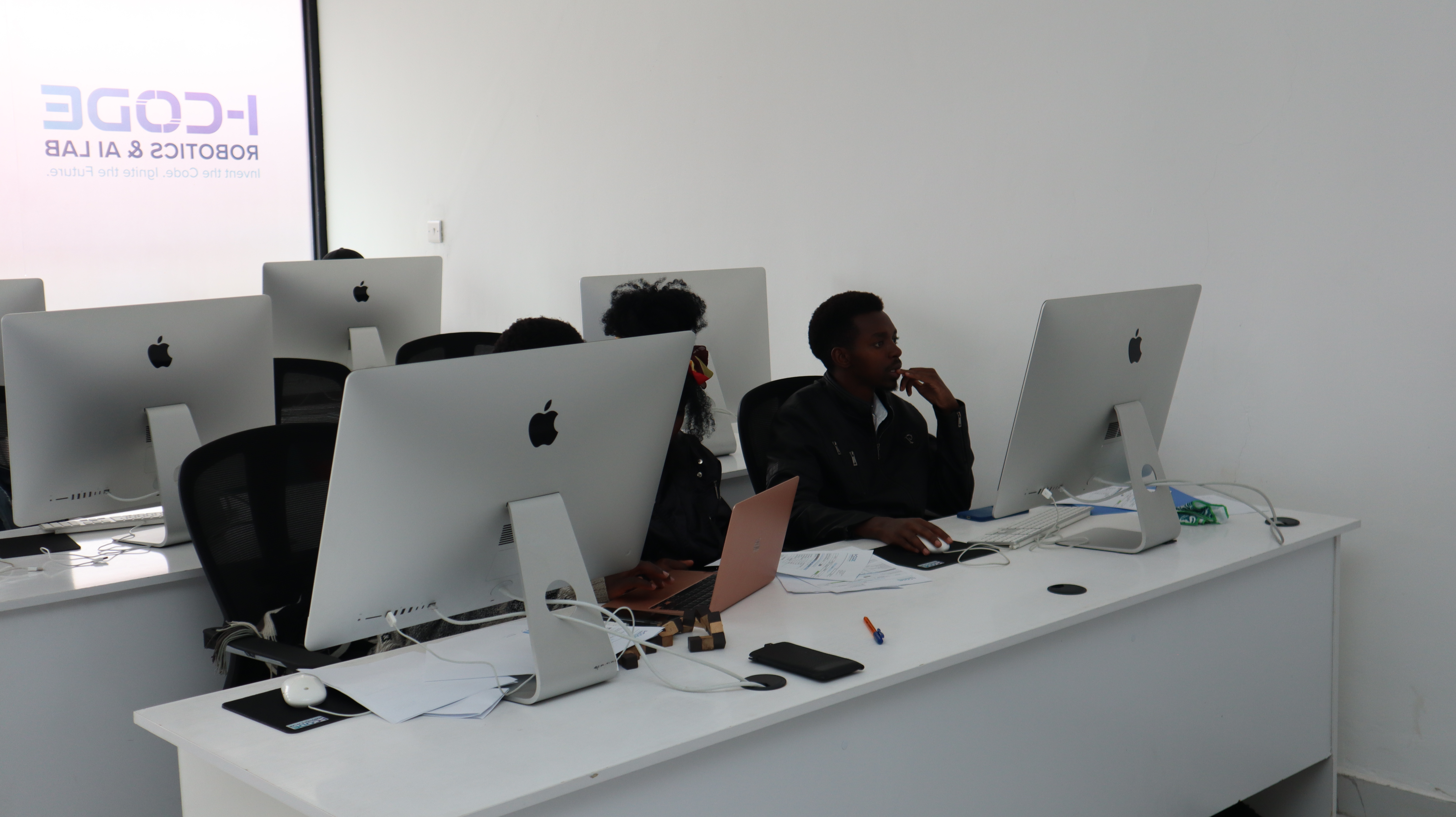 Students in focused coding session at the i-CODE Mac lab