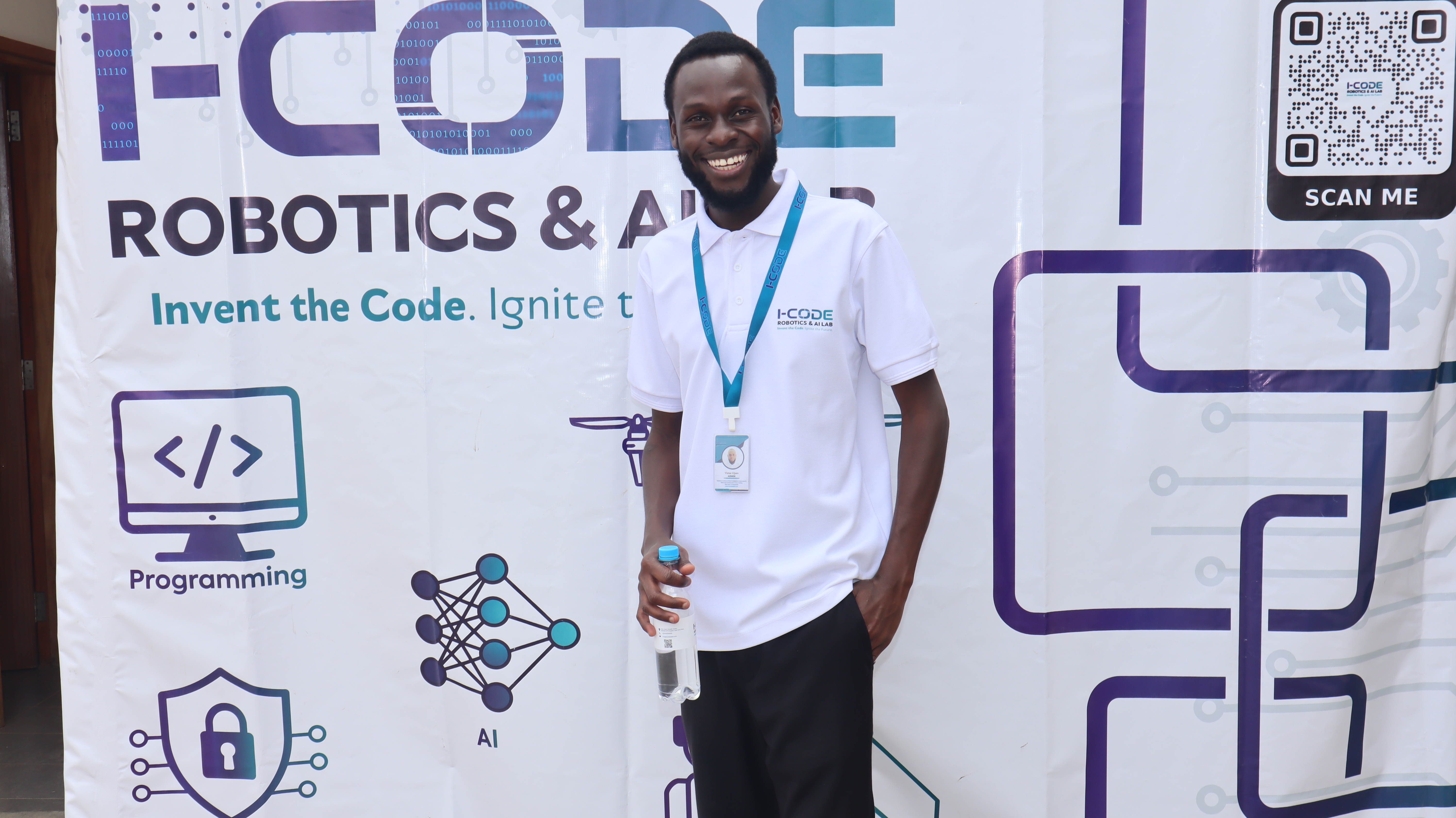 i-CODE team member at the Innovation Expo exhibition backdrop