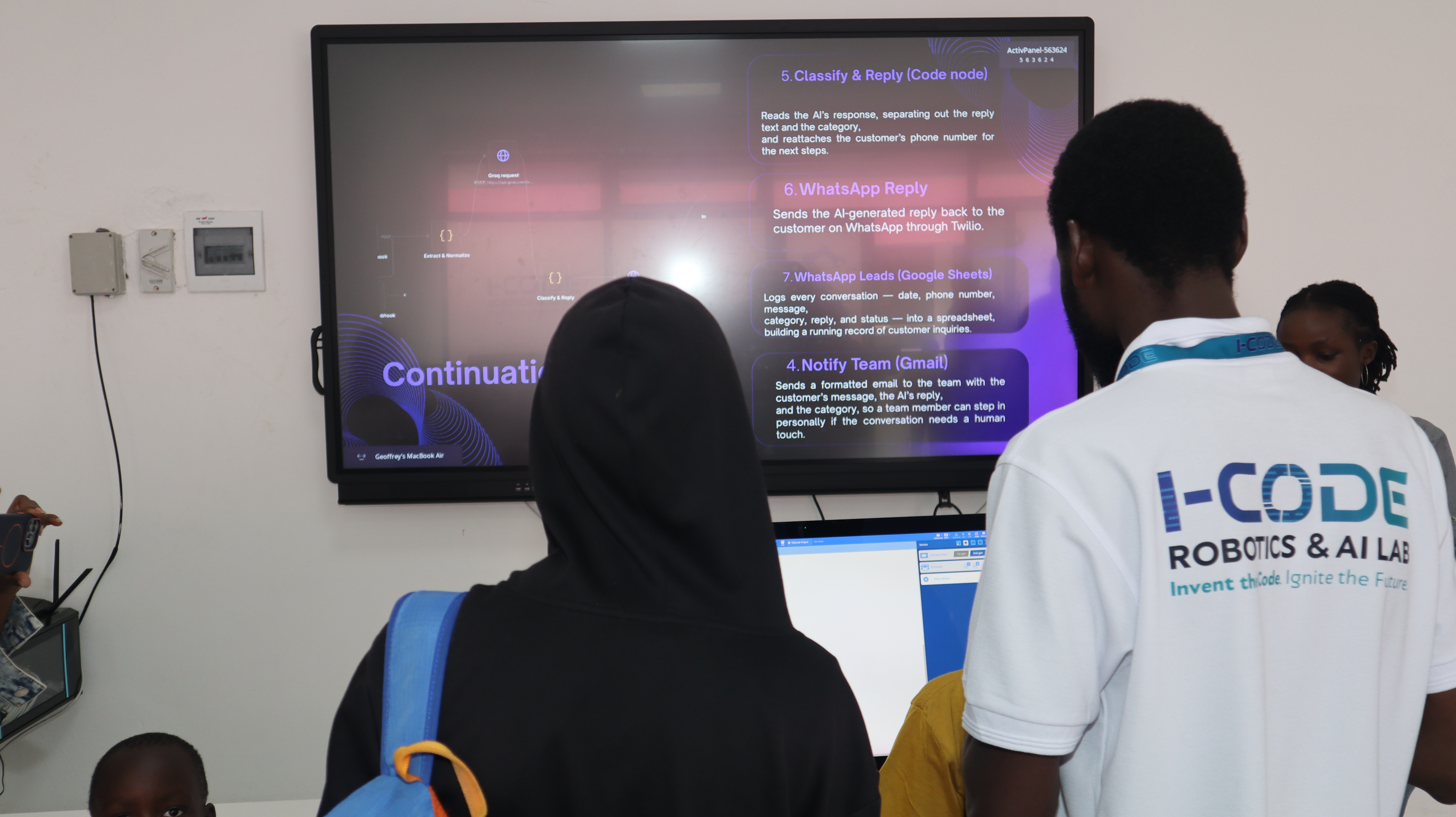 Visitors engage with AI automation demo at i-CODE lab